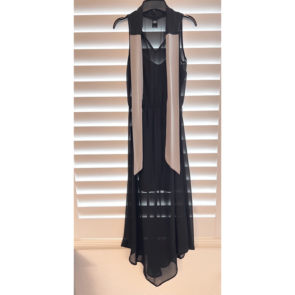 Sleeveless black dress with neck tie. Partially lined.